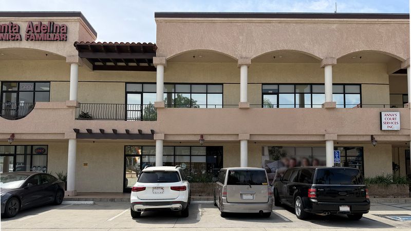 The covered walkway outside the practice, with the entrance facing the street.